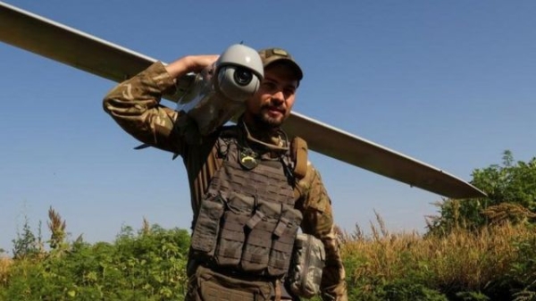 A Ukrainian serviceman carries a reconnaissance unmanned aerial vehicle to a launch position near a frontline, amid Russia’s attack on Ukraine, in Donetsk region, Ukraine July 6