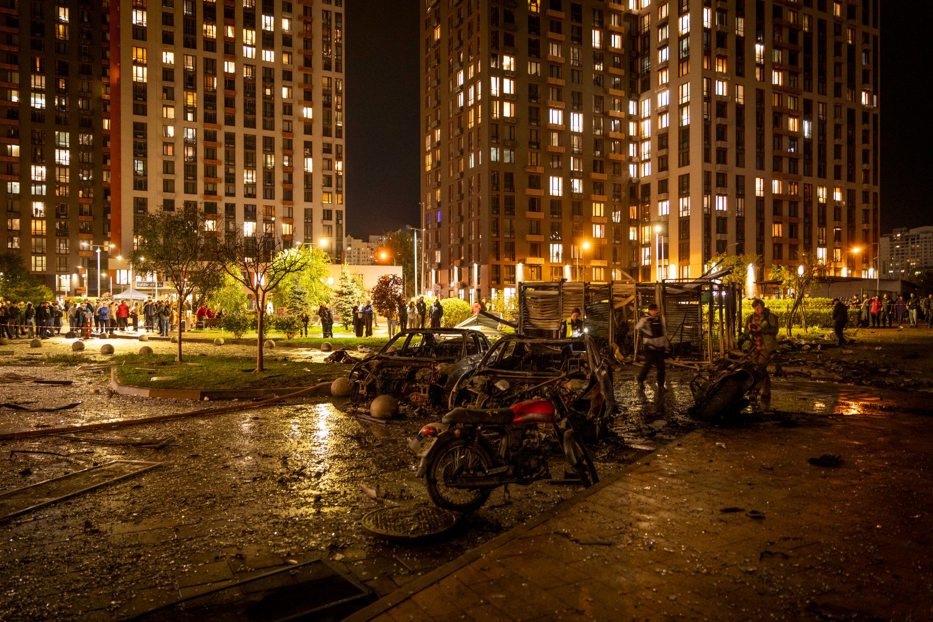 Burned-out cars and motorcycles stand in the courtyard of a residential building following a Russian attack in Kyiv, Ukraine, on Oct. 12, 2026. 